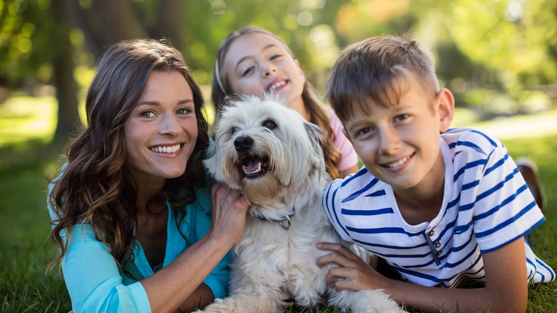 Family posed with their pet in a lawn in Columbus, OH.