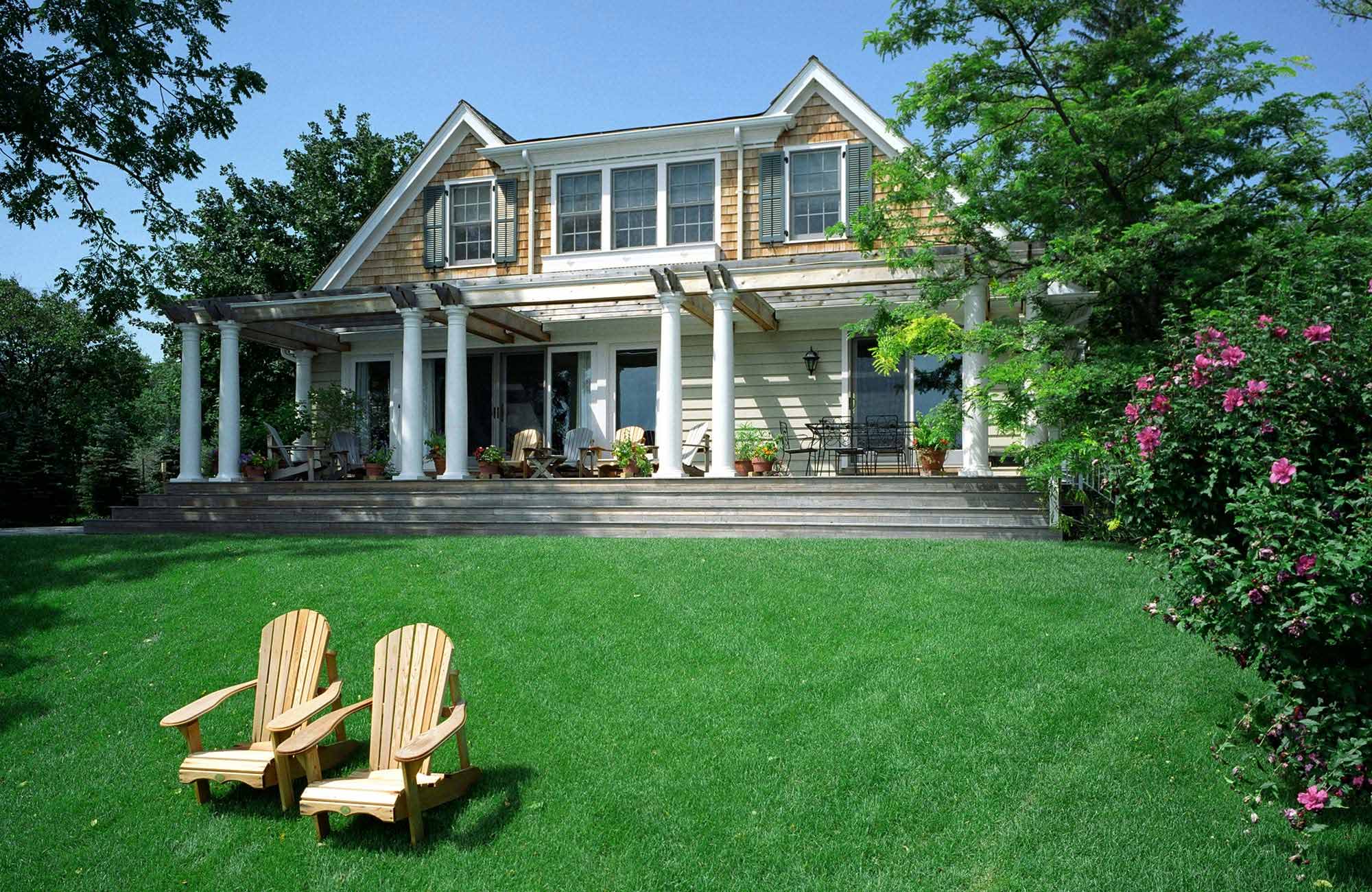 Beautiful, vivid green lawn with chairs in front of a columned home near Columbus, OH.