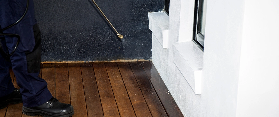 A technician applying perimeter pest control to a home in Columbus, OH.